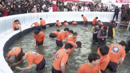 В Южной Корее на фестивале ловят рыбу голыми руками подо льдом